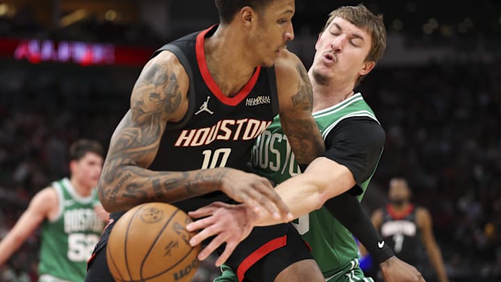 Feb 4, 2026; Houston, Texas, USA; Boston Celtics guard Baylor Scheierman (55) steals the ball from Houston Rockets forward Jabari Smith Jr. (10) during the second quarter at Toyota Center. Mandatory Credit: Troy Taormina-Imagn Images