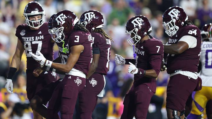 Texas A&M Aggies quarterback Marcel Reed (10) celebrates with teammates after a touchdown during the first half against the Louisiana State Tigers at Tiger Stadium. 