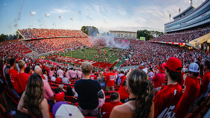 Aug 28, 2025; Raleigh, North Carolina, USA; North Carolina State Wolfpack fans celebrate the team running out before the first half of the game against East Carolina Pirates at Carter-Finley Stadium. Mandatory Credit: Jaylynn Nash-Imagn Images Aug 28, 2025; Raleigh, North Carolina, USA; North Carolina State Wolfpack fans celebrate the team running out before the first half of the game against East Carolina Pirates at Carter-Finley Stadium. Mandatory Credit: Jaylynn Nash-Imagn Images