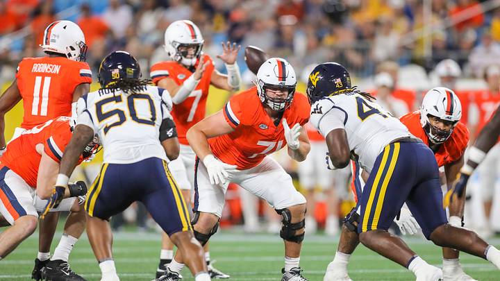 Sep 19, 2026; Charlotte, North Carolina, USA; Virginia Cavaliers offensive lineman Monroe Mills (71) drops back to block during the first quarter against the West Virginia Mountaineers at Bank of America Stadium. Mandatory Credit: Ben Queen-Imagn Images Sep 19, 2026; Charlotte, North Carolina, USA; Virginia Cavaliers offensive lineman Monroe Mills (71) drops back to block during the first quarter against the West Virginia Mountaineers at Bank of America Stadium. Mandatory Credit: Ben Queen-Imagn Images