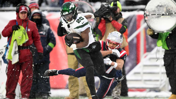 Jan 7, 2024; Foxborough, Massachusetts, USA; New York Jets running back Breece Hall (20) breaks a tackle by New England Patriots cornerback Myles Bryant (27) during the second half at Gillette Stadium. Jan 7, 2024; Foxborough, Massachusetts, USA; New York Jets running back Breece Hall (20) breaks a tackle by New England Patriots cornerback Myles Bryant (27) during the second half at Gillette Stadium.