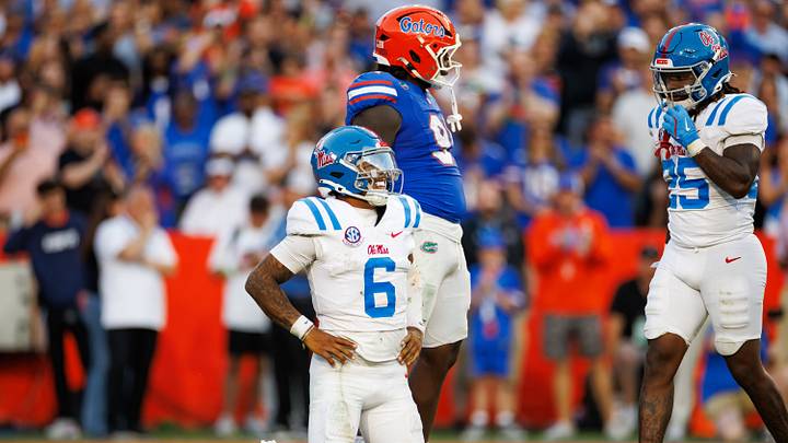 Mississippi Rebels quarterback Trinidad Chambliss winces from the ground while Florida Gators defensive lineman Jeramiah McCloud makes a gesture during the second half at Ben Hill Griffin Stadium.  Mandatory Credit: Matt Pendleton-Imagn Images
