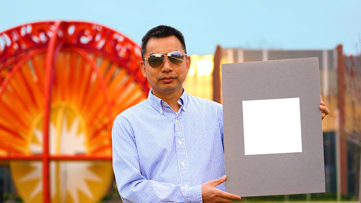 Xiulin Ruan and a sample of his cooling paint.