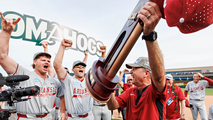 Arkansas Razorback coach Dave Van Horn lifts the Fayetteville Super Regional Trophy as his players celebrate in Baum Walker Stadium on June 8