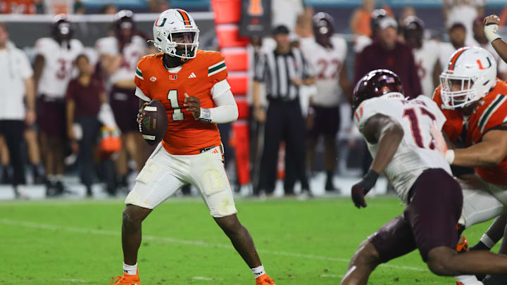 Sep 27, 2024; Miami Gardens, Florida, USA; Miami Hurricanes quarterback Cam Ward (1) looks for a passing option against the Virginia Tech Hokies during the fourth quarter at Hard Rock Stadium. Mandatory Credit: Sam Navarro-Imagn Images