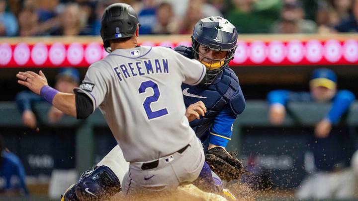 Twins catcher Victor Caratini tags out Rockies right fielder Tyler Freeman