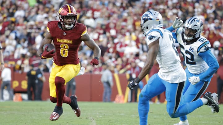 Oct 20, 2024; Landover, Maryland, USA; Washington Commanders running back Brian Robinson Jr. (8) carries the ball as Carolina Panthers cornerback Michael Jackson (2) and Panthers linebacker DJ Johnson (52) defends during the second half at Northwest Stadium. Mandatory Credit: Amber Searls-Imagn Images Oct 20, 2024; Landover, Maryland, USA; Washington Commanders running back Brian Robinson Jr. (8) carries the ball as Carolina Panthers cornerback Michael Jackson (2) and Panthers linebacker DJ Johnson (52) defends during the second half at Northwest Stadium. Mandatory Credit: Amber Searls-Imagn Images