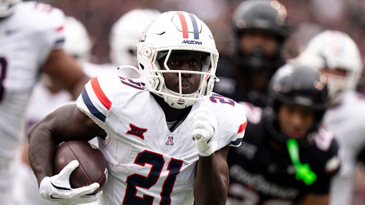 Arizona Wildcats running back Ismail Mahdi (21) runs for a touchdown in the first quarter of the NCAA football game between the Cincinnati Bearcats and Arizona Wildcats at Nippert Stadium in Cincinnati on Nov. 15, 2025. Arizona Wildcats running back Ismail Mahdi (21) runs for a touchdown in the first quarter of the NCAA football game between the Cincinnati Bearcats and Arizona Wildcats at Nippert Stadium in Cincinnati on Nov. 15, 2025.
