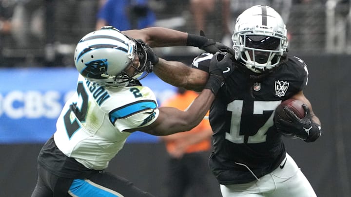 Sep 22, 2024; Paradise, Nevada, USA; Las Vegas Raiders wide receiver Davante Adams (17) carries the ball against Carolina Panthers cornerback Michael Jackson (2) in the first half at Allegiant Stadium. 