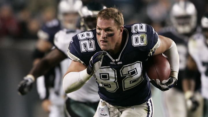 Dallas Cowboys tight end Jason Witten carries the ball for a 53 yard reception after losing his helmet after he was hit by Philadelphia Eagles safety Quintin Mikell (not pictured) and cornerback William James (not pictured) in the fourth quarter at Lincoln Financial Field in Philadelphia, PA.  Dallas won the game 38-17. 