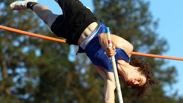 Catlin Gabel junior Teddy Ratliff soars over the bar in the pole vault competition during a Lewis & Clark League meet at Valley Catholic High School.