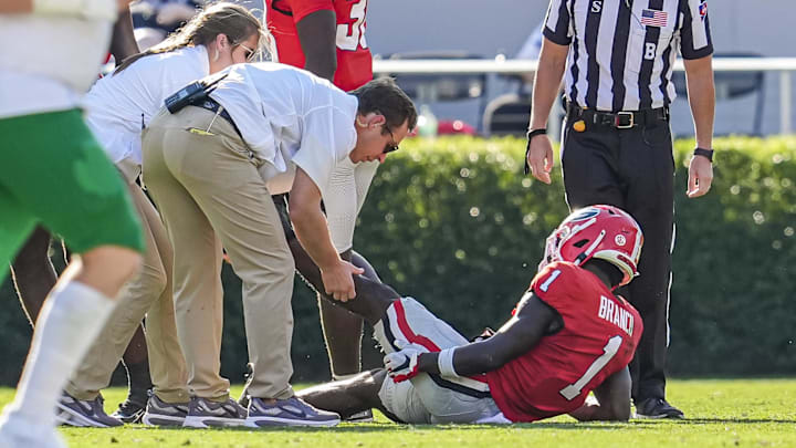 Aug 30, 2025; Athens, Georgia, USA; Georgia Bulldogs wide receiver Zachariah Branch (1) is assisted after fielding a punt against the Marshall Thundering Herd at Sanford Stadium. Mandatory Credit: Dale Zanine-Imagn Images