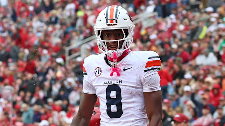 Auburn Tigers wide receiver Cam Coleman celebrates after scoring a touchdown defended by Arkansas Razorbacks defensive back Julian Neal (23) during the first quarter at Donald W. Reynolds Razorback Stadium. 