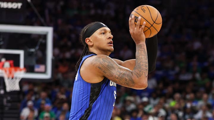 Apr 27, 2025; Orlando, Florida, USA; Orlando Magic forward Paolo Banchero (5) shoots a three point shot against the Boston Celtics in the first quarter during game four of first round for the 2025 NBA Playoffs at Kia Center. Mandatory Credit: Nathan Ray Seebeck-Imagn Images  