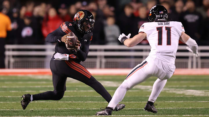 Nov 1, 2025; Salt Lake City, Utah, USA; Utah Utes quarterback Devon Dampier (4) runs after a catch against Cincinnati Bearcats linebacker Jake Golday (11) during the second half at Rice-Eccles Stadium. Mandatory Credit: Rob Gray-Imagn Images