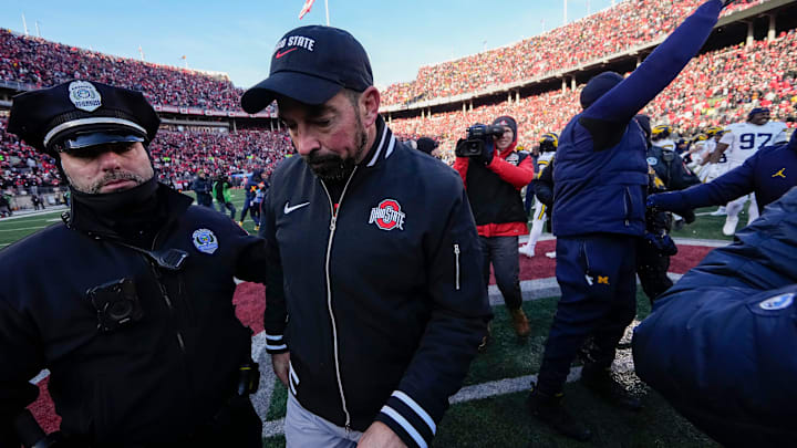 Ohio State Buckeyes head coach Ryan Day leaves the field shaking hands with Michigan Wolverines head coach Sherrone Moore, right, following the NCAA football game at Ohio Stadium in Columbus on Saturday, Nov. 30, 2024. Michigan won 13-10.