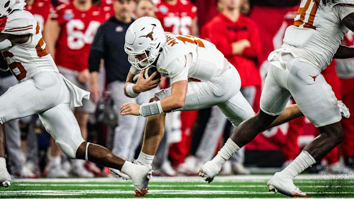 Jan 10, 2025; Arlington, TX, USA; Texas Longhorns quarterback Arch Manning (16) carries the ball for a first down in the second quarter as the Texas Longhorns play the Ohio State Buckeyes in the Cotton Bowl College Football Playoff semi-final at AT&T Stadium in Dallas, Texas. Mandatory Credit: Sara Diggins/USA TODAY Network via Imagn Images