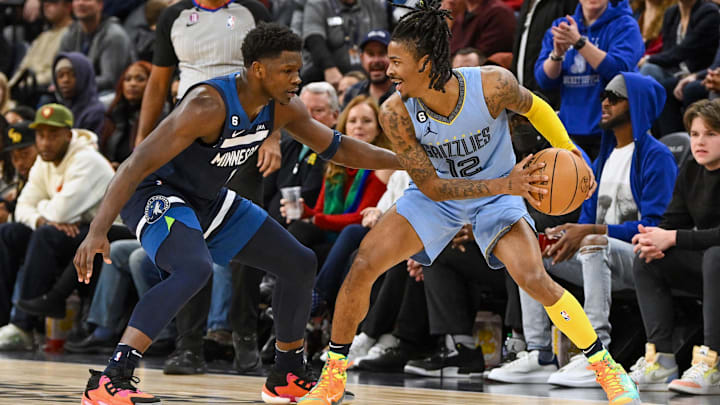 Nov 30, 2022; Minneapolis, Minnesota, USA;  Memphis Grizzlies guard Ja Morant (12) protects the ball