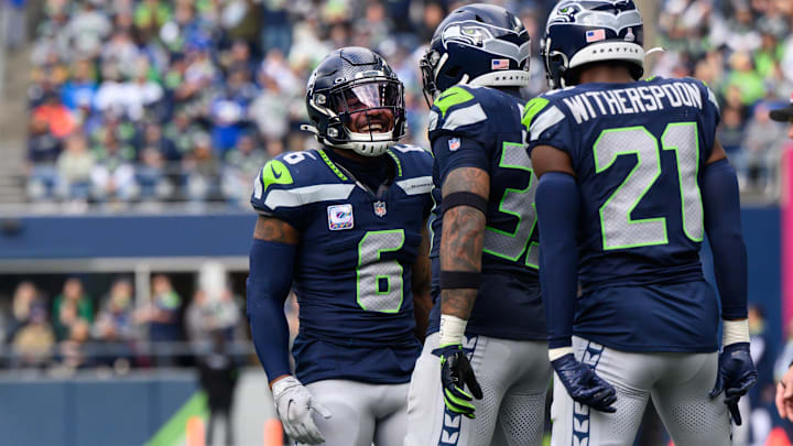 Oct 22, 2023; Seattle, Washington, USA; Seattle Seahawks safety Quandre Diggs (6) and safety Jamal Adams (33) and cornerback Devon Witherspoon (21) celebrate after the defense made a play against the Arizona Cardinals during the second half at Lumen Field.