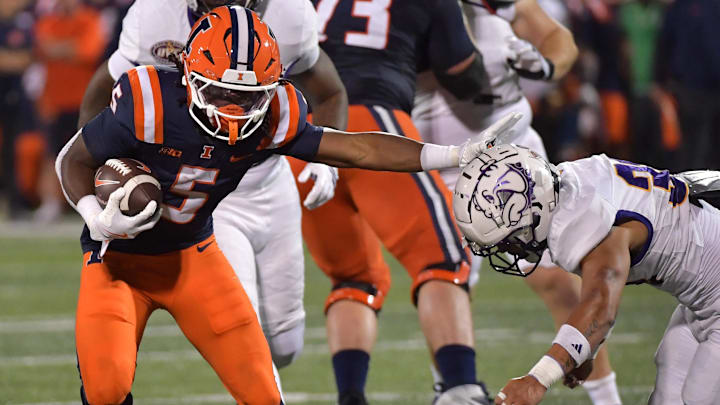 Aug 29, 2025; Champaign, Illinois, USA; Illinois Fighting Illini running back Ca'Lil Valentine (5) stiff arms Western Illinois Leathernecks defensive back Christian Pierce (3) during the second half at Memorial Stadium. Mandatory Credit: Ron Johnson-Imagn Images Aug 29, 2025; Champaign, Illinois, USA; Illinois Fighting Illini running back Ca'Lil Valentine (5) stiff arms Western Illinois Leathernecks defensive back Christian Pierce (3) during the second half at Memorial Stadium. Mandatory Credit: Ron Johnson-Imagn Images
