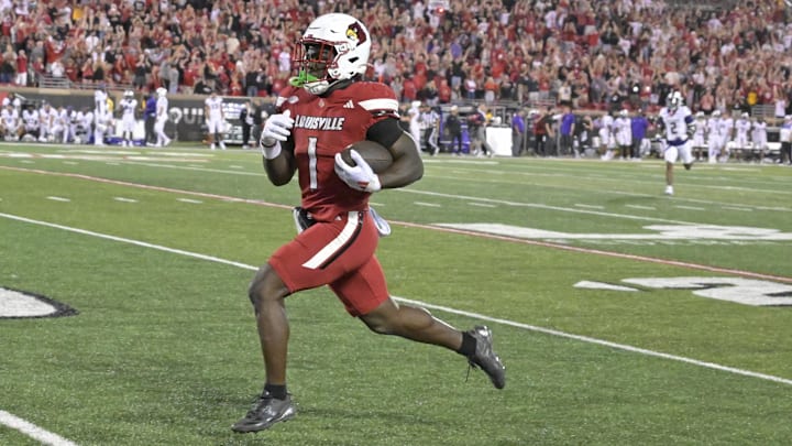 Sep 5, 2025; Louisville, Kentucky, USA;  Louisville Cardinals running back Isaac Brown (1) runs the ball for a touchdown against the James Madison Dukes during the second half at L&N Federal Credit Union Stadium. Mandatory Credit: Jamie Rhodes-Imagn Images