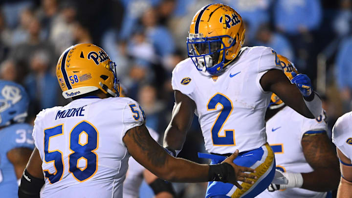 Oct 29, 2022; Chapel Hill, North Carolina, USA; Pittsburgh Panthers running back Israel Abanikanda (2) celebrates with offensive lineman Terrence Moore (58) after scoring a touchdown in the first quarter at Kenan Memorial Stadium. Mandatory Credit: Bob Donnan-Imagn Images