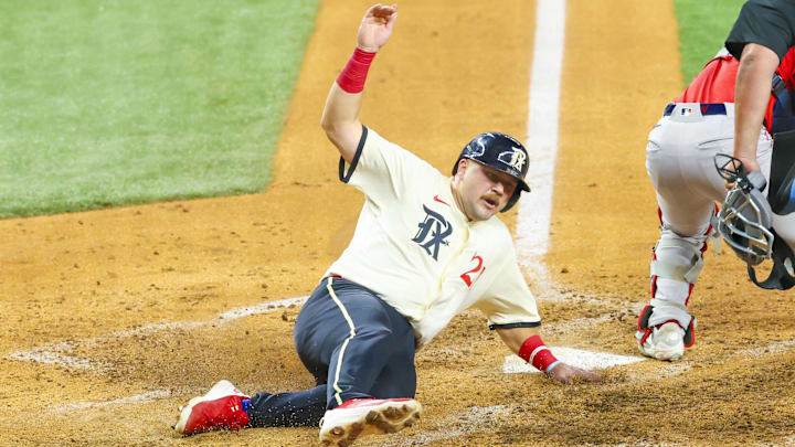 Mar 28, 2025; Arlington, Texas, USA;  Texas Rangers first baseman Jake Burger (21) scores during the sixth inning against the Boston Red Sox at Globe Life Field.