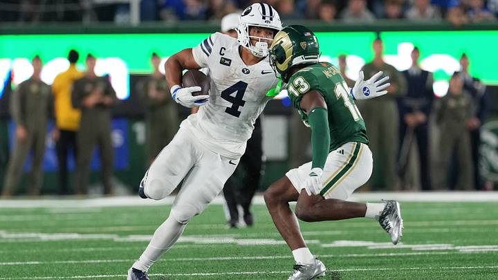 Sep 19, 2026; Fort Collins, Colorado, USA;  BYU Cougars running back Lj Martin (4) avoids a tackle by Colorado State Rams safety Elijah Mc-Cantos (13) at Sonny Lubick Field at Canvas Stadium.  Mandatory Credit: Andrew Rydland-Imagn Images
