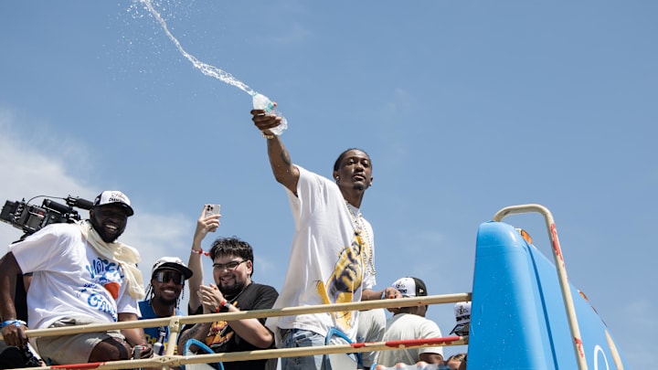 Jun 24, 2025; Oklahoma City, OK, USA;  Oklahoma City Thunder player Jalen Williams splashes water on fans during the 2025 NBA Oklahoma City Thunder championship parade. Mandatory Credit: Brett Rojo-Imagn Images
