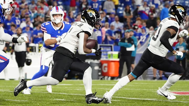 Sep 23, 2024; Orchard Park, New York, USA; Jacksonville Jaguars running back Travis Etienne Jr. (1) runs with the ball against the Buffalo Bills during the second half at Highmark Stadium. 
