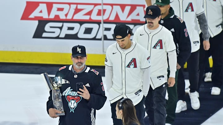 Mar 7, 2024; Tempe, Arizona, USA; Arizona Diamondbacks manager Torey Lovullo leads his team onto the ice at a Coyotes game.