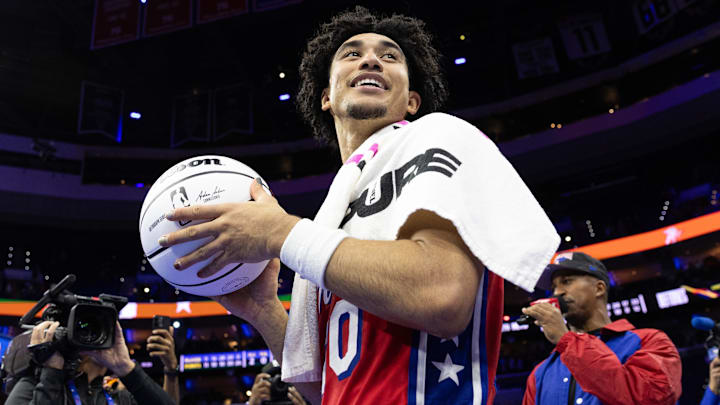 Nov 22, 2024; Philadelphia, Pennsylvania, USA; Philadelphia 76ers guard Jared McCain (20) prepares to throw a game ball to fans after a victory against the Brooklyn Nets at Wells Fargo Center. Mandatory Credit: Bill Streicher-Imagn Images