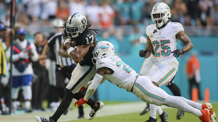 Las Vegas Raiders wide receiver Davante Adams (17) runs with the football as Miami Dolphins safety DeShon Elliott (21) attempts a tackle during the fourth quarter at Hard Rock Stadium. Las Vegas Raiders wide receiver Davante Adams (17) runs with the football as Miami Dolphins safety DeShon Elliott (21) attempts a tackle during the fourth quarter at Hard Rock Stadium.
