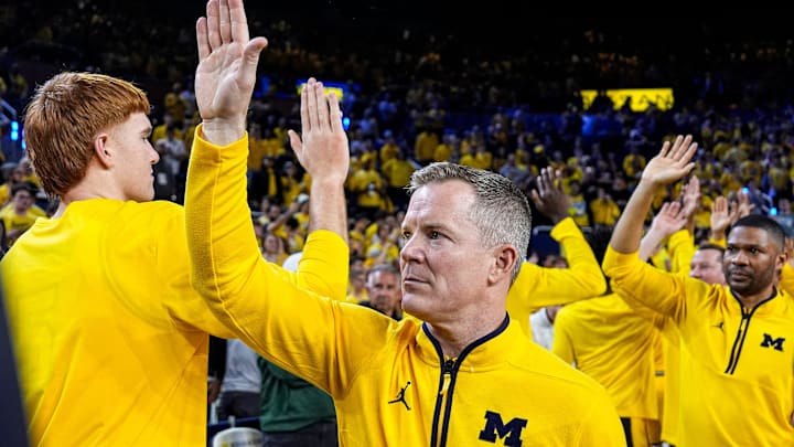 Michigan head coach Dusty May high-fives players and coaches after 90-80 win over Michigan State at Crisler Center in Ann Arbor on Sunday, March 8, 2026.