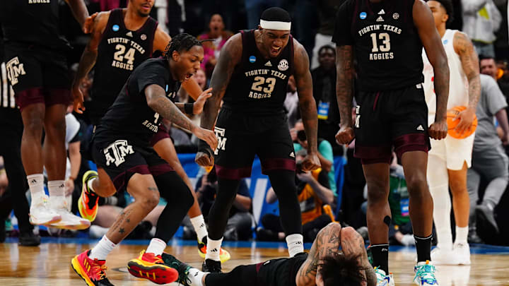 Mar 24, 2024; Memphis, TN, USA;  Texas A&M Aggies guard Wade Taylor IV (4) and guard Tyrece Radford (23) and forward Solomon Washington (13) celebrate with Andersson Garcia (11) after he scored at the buzzer to go to overtime against the Houston Cougars n the second round of the 2024 NCAA Tournament at FedExForum. Mandatory Credit: John David Mercer-Imagn Images
