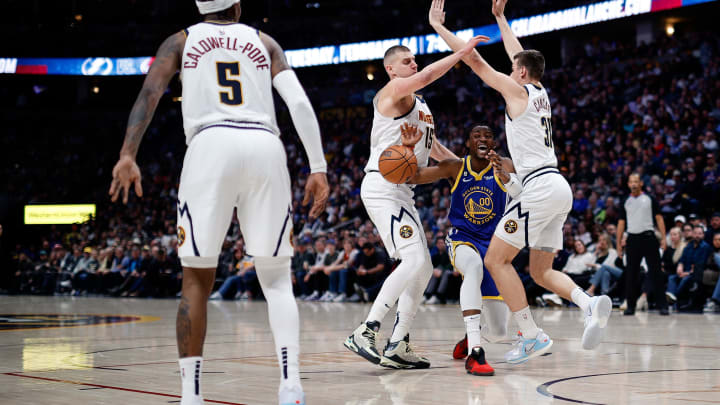 Feb 2, 2023; Denver, Colorado, USA; Golden State Warriors forward Jonathan Kuminga (00) loses control of the ball against Denver Nuggets center Nikola Jokic (15) and forward Vlatko Cancar (31) as guard Kentavious Caldwell-Pope (5) defends in the second quarter at Ball Arena. Feb 2, 2023; Denver, Colorado, USA; Golden State Warriors forward Jonathan Kuminga (00) loses control of the ball against Denver Nuggets center Nikola Jokic (15) and forward Vlatko Cancar (31) as guard Kentavious Caldwell-Pope (5) defends in the second quarter at Ball Arena.