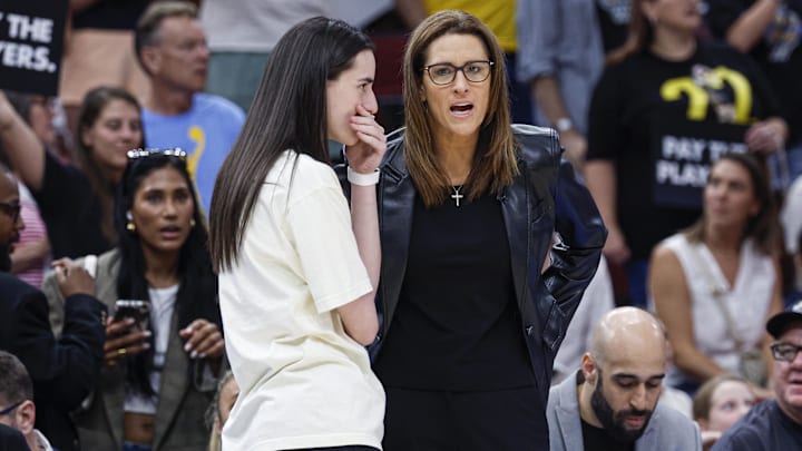 Jul 27, 2025; Chicago, Illinois, USA; Indiana Fever head coach Stephanie White (R) talks to injured guard Caitlin Clark (L) before a basketball game against the Chicago Sky at United Center. Mandatory Credit: Kamil Krzaczynski-Imagn Images