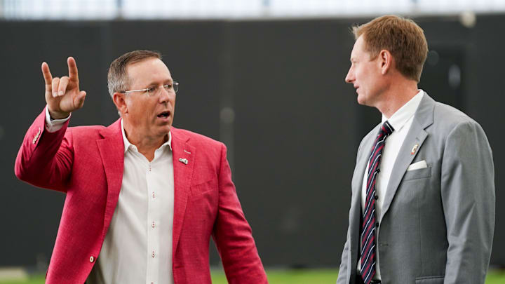 University of Cincinnati head football coach Scott Satterfield, left, and athletic director John Cunningham, right, have a conversation, Wednesday, June 11, 2025, at Sheakley Indoor Performance Center in Cincinnati. University of Cincinnati head football coach Scott Satterfield, left, and athletic director John Cunningham, right, have a conversation, Wednesday, June 11, 2025, at Sheakley Indoor Performance Center in Cincinnati.