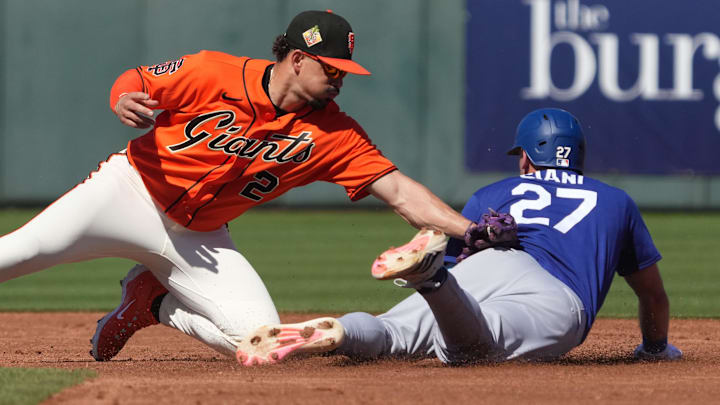 Los Angeles Dodgers' Michael Siani steals second base under the tag by San Francisco Giants shortstop Willy Adames.