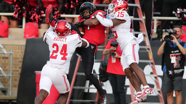 Sep 30, 2023; Lubbock, Texas, USA;  Texas Tech Red Raiders wide receiver Myles Price (1) catches a touchdown pass against Houston Cougars defensive back Malik Fleming (15) and defensive safety AJ Haulcy (24) in the second half at Jones AT&T Stadium and Cody Campbell Field. Mandatory Credit: Michael C. Johnson-Imagn Images