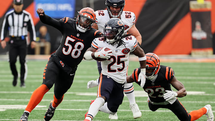 Nov 2, 2025; Cincinnati, Ohio, USA; Chicago Bears running back Kyle Monangai (25) runs the ball against Cincinnati Bengals defensive end Joseph Ossai (58) and cornerback Dax Hill (23) during the third quarter at Paycor Stadium. Mandatory Credit: Joseph Maiorana-Imagn Images