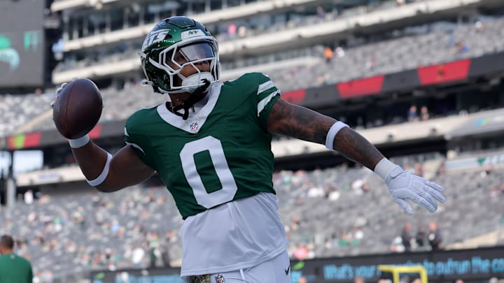 New York Jets running back Braelon Allen (0) plays catch with fans before a game against the Indianapolis Colts at MetLife Stadium. 