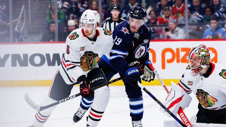 Oct 30, 2025; Winnipeg, Manitoba, CAN;  Winnipeg Jets forward Jonathan Toews (19) jostles for position with Chicago Blackhawks defenseman Sam Rinzel (6) during the second period at Canada Life Centre. Mandatory Credit: Terrence Lee-Imagn Images Oct 30, 2025; Winnipeg, Manitoba, CAN;  Winnipeg Jets forward Jonathan Toews (19) jostles for position with Chicago Blackhawks defenseman Sam Rinzel (6) during the second period at Canada Life Centre. Mandatory Credit: Terrence Lee-Imagn Images