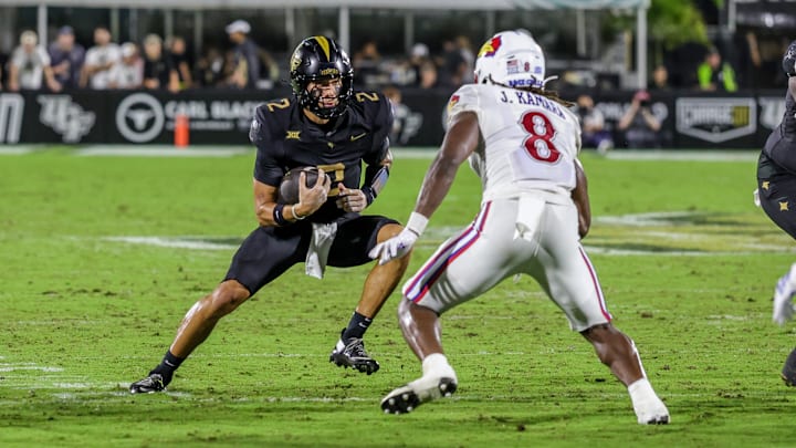 Oct 4, 2025; Orlando, Florida, USA; UCF Knights quarterback Tayven Jackson (2) runs the ball in front of Kansas Jayhawks linebacker Jon Jon Kamara (8) during the second quarter at FBC Mortgage Stadium. Mandatory Credit: Mike Watters-Imagn Images Oct 4, 2025; Orlando, Florida, USA; UCF Knights quarterback Tayven Jackson (2) runs the ball in front of Kansas Jayhawks linebacker Jon Jon Kamara (8) during the second quarter at FBC Mortgage Stadium. Mandatory Credit: Mike Watters-Imagn Images