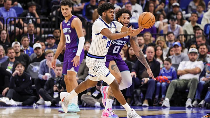 Dec 26, 2025; Orlando, Florida, USA; Orlando Magic guard Jase Richardson (11) passes the ball in front of Charlotte Hornets forward Miles Bridges (0) during the second half at Kia Center. Mandatory Credit: Mike Watters-Imagn Images