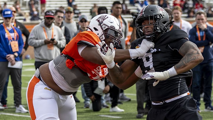 American team offensive lineman Carson Vinson of Alabama A&M spars with defensive lineman Kyle Kennard of South Carolina.