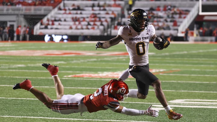 Oct 11, 2025; Salt Lake City, Utah, USA; Arizona State Sun Devils wide receiver Jordyn Tyson (0) runs for a touchdown against Utah Utes cornerback Smith Snowden (2) during the third quarter at Rice-Eccles Stadium. Mandatory Credit: Rob Gray-Imagn Images