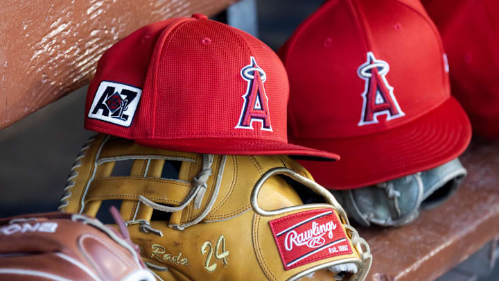 Feb 28, 2025; Phoenix, Arizona, USA; Detailed view of the Los Angeles Angels logo on a hat in the dugout during a spring training game at Camelback Ranch-Glendale. Mandatory Credit: Mark J. Rebilas-Imagn Images Feb 28, 2025; Phoenix, Arizona, USA; Detailed view of the Los Angeles Angels logo on a hat in the dugout during a spring training game at Camelback Ranch-Glendale. Mandatory Credit: Mark J. Rebilas-Imagn Images
