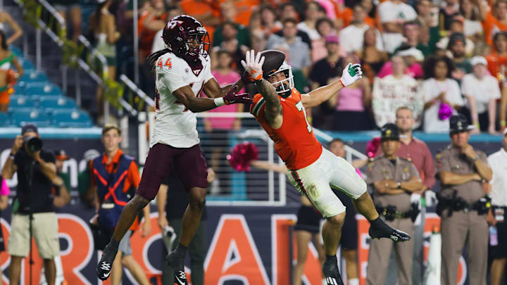 Sep 27, 2024; Miami Gardens, Florida, USA; Miami Hurricanes wide receiver Xavier Restrepo (7) jumps but cannot make a catch against Virginia Tech Hokies cornerback Dorian Strong (44) during the third quarter at Hard Rock Stadium. Mandatory Credit: Sam Navarro-Imagn Images Sep 27, 2024; Miami Gardens, Florida, USA; Miami Hurricanes wide receiver Xavier Restrepo (7) jumps but cannot make a catch against Virginia Tech Hokies cornerback Dorian Strong (44) during the third quarter at Hard Rock Stadium. Mandatory Credit: Sam Navarro-Imagn Images