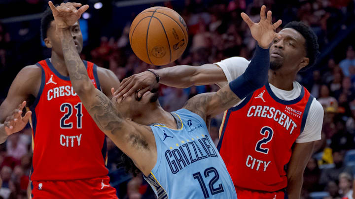 Dec 27, 2024; New Orleans, Louisiana, USA; Memphis Grizzlies guard Ja Morant (12) gets a hand in the face from New Orleans Pelicans forward Herbert Jones (2) during the second half at Smoothie King Center. Mandatory Credit: Matthew Hinton-Imagn Images